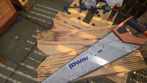 cutting timber with ciruclar saw and hand saw for garden bench