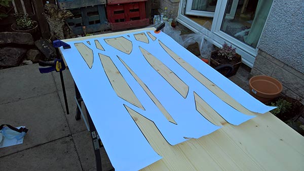 using a paper template for designing trees onto timber sliding screen